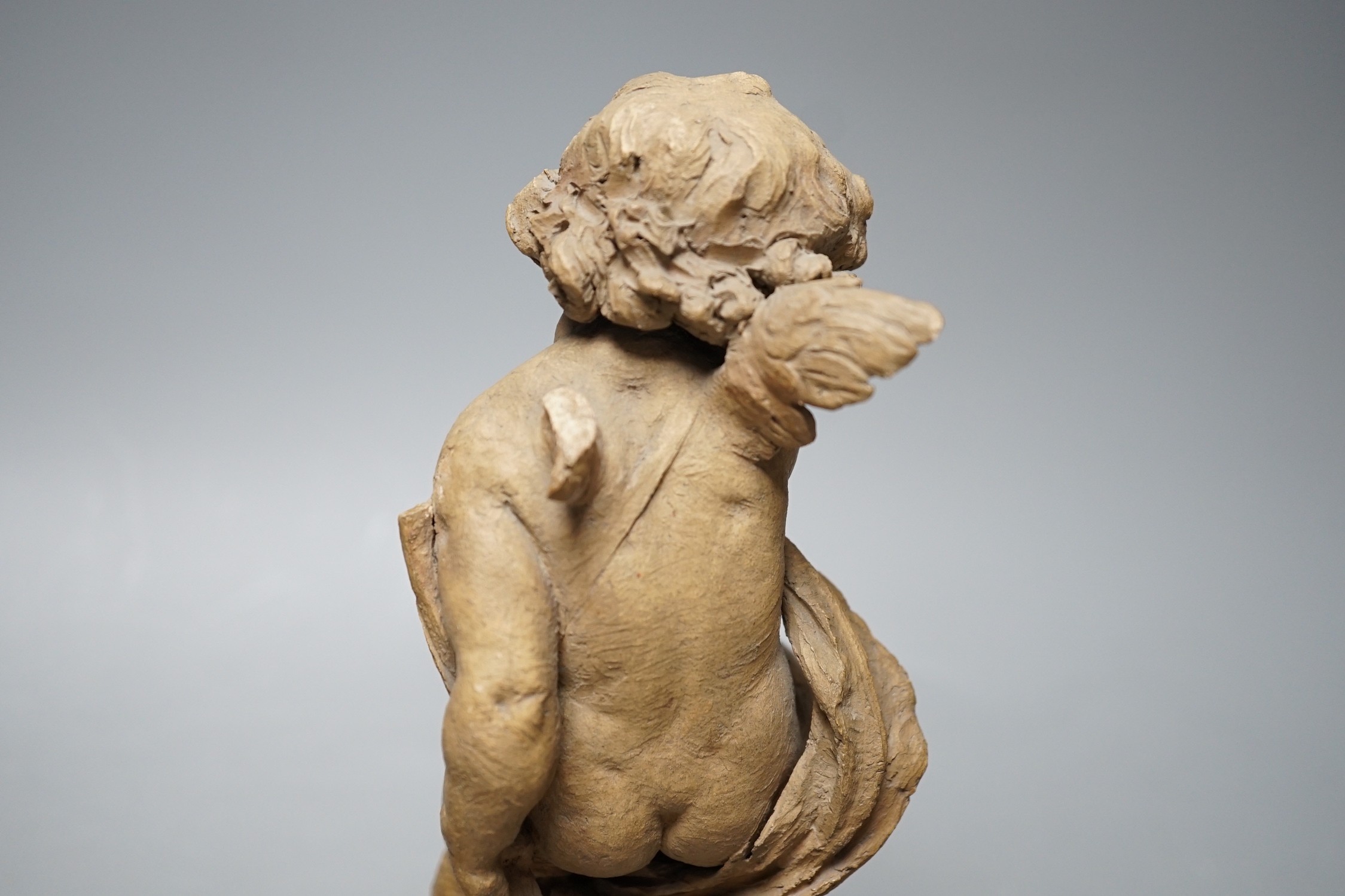 Two 19th century French terracotta cherubs and one other Cupid, after Clodion, all on giltwood stands, tallest 23.5cm